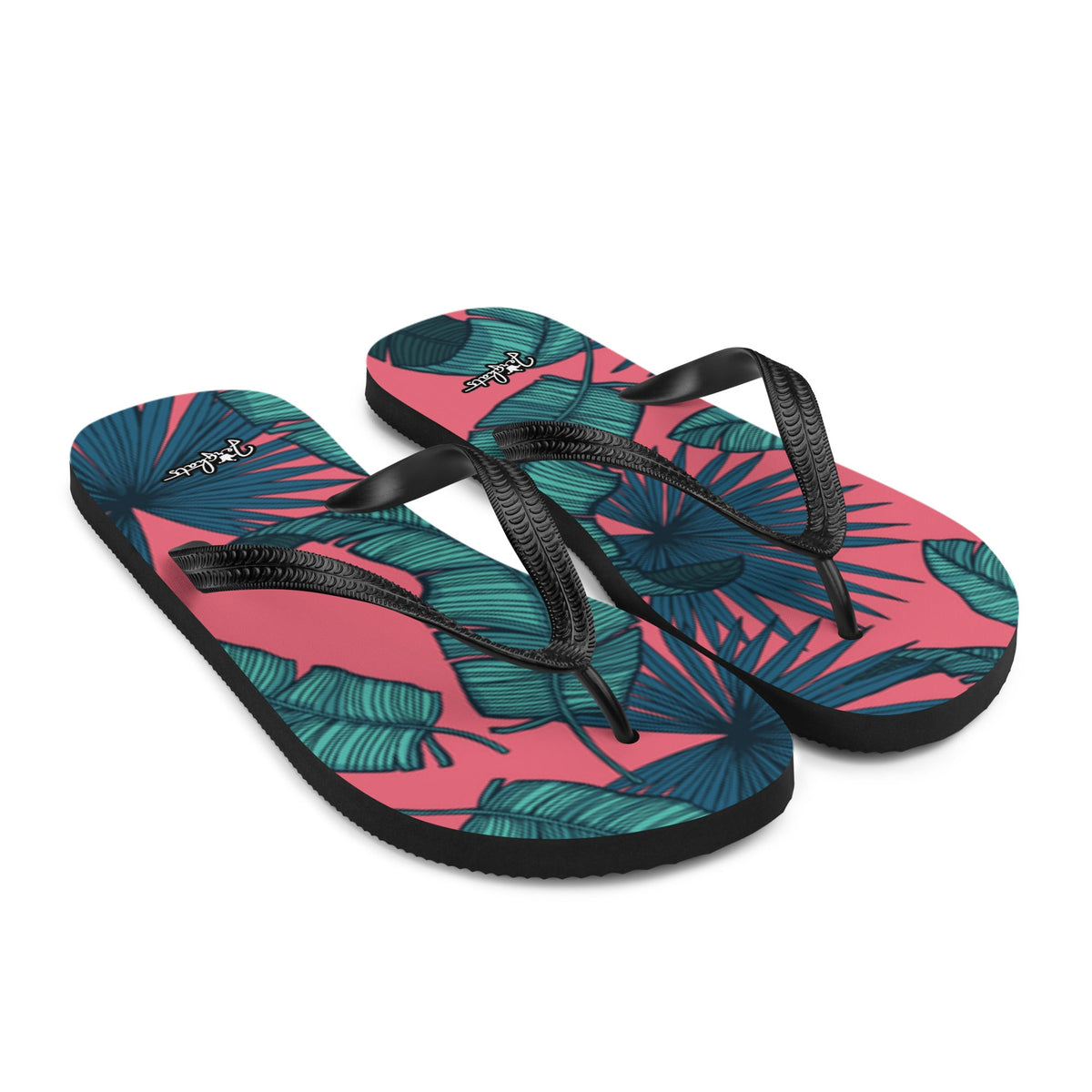 JERGHATS flip-flops with a pink and teal tropical palm leaf print, black rubber soles, and black Y-shaped straps.