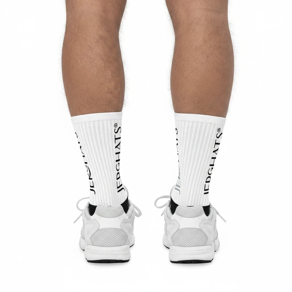 JERGHATS crew socks with white ribbed legs and black logo branding worn with white sneakers