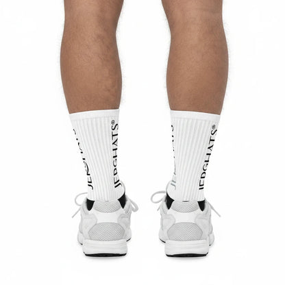 JERGHATS crew socks with white ribbed legs and black logo branding worn with white sneakers
