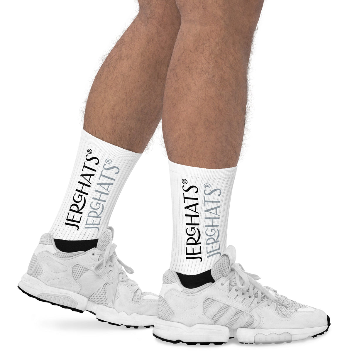 JERGHATS crew socks with white ribbed leg featuring black logo print and cushioned black foot worn with white sneakers